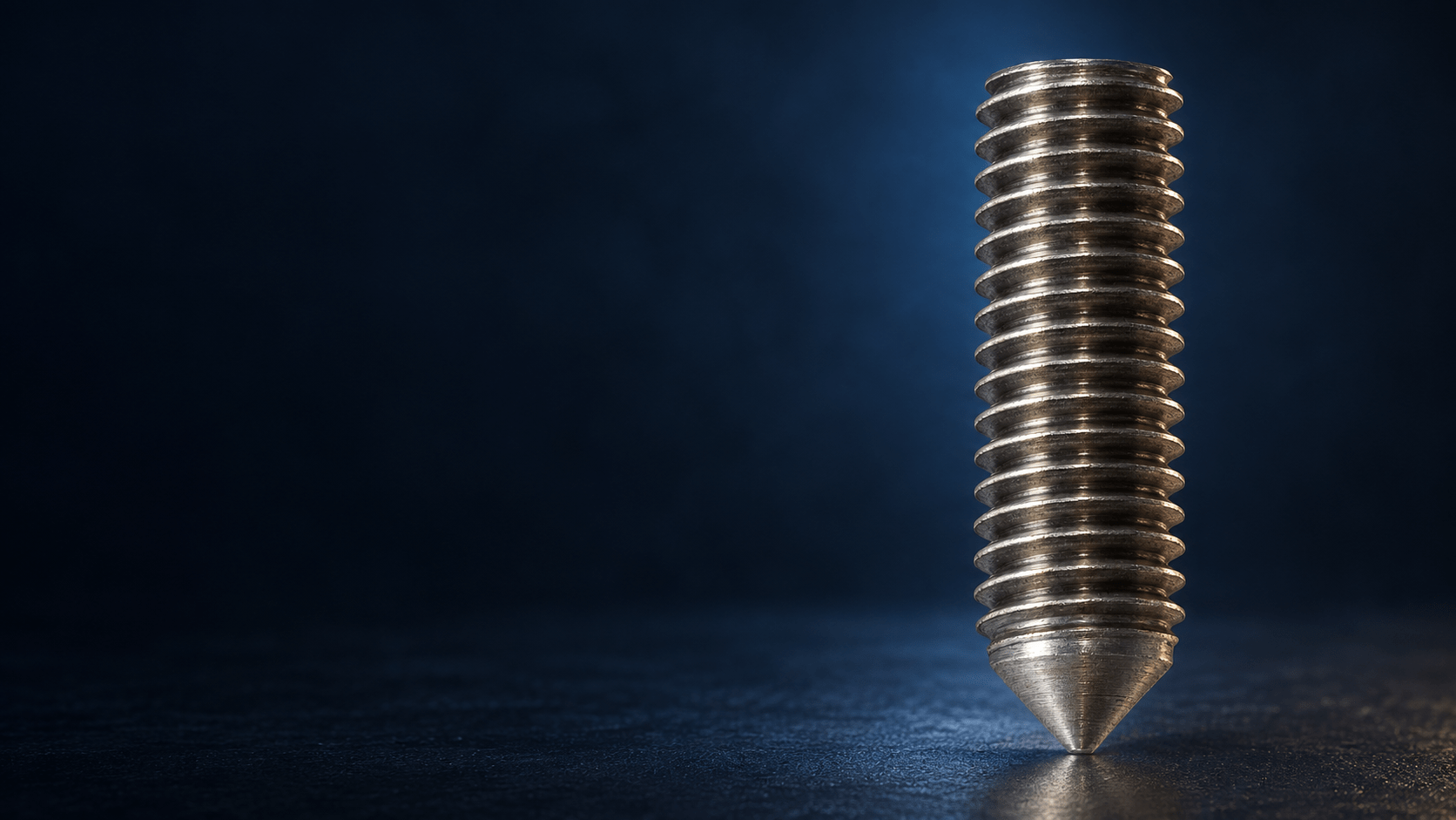 Unwelded FD stud with continuous thread and conical tip in blue industrial lighting