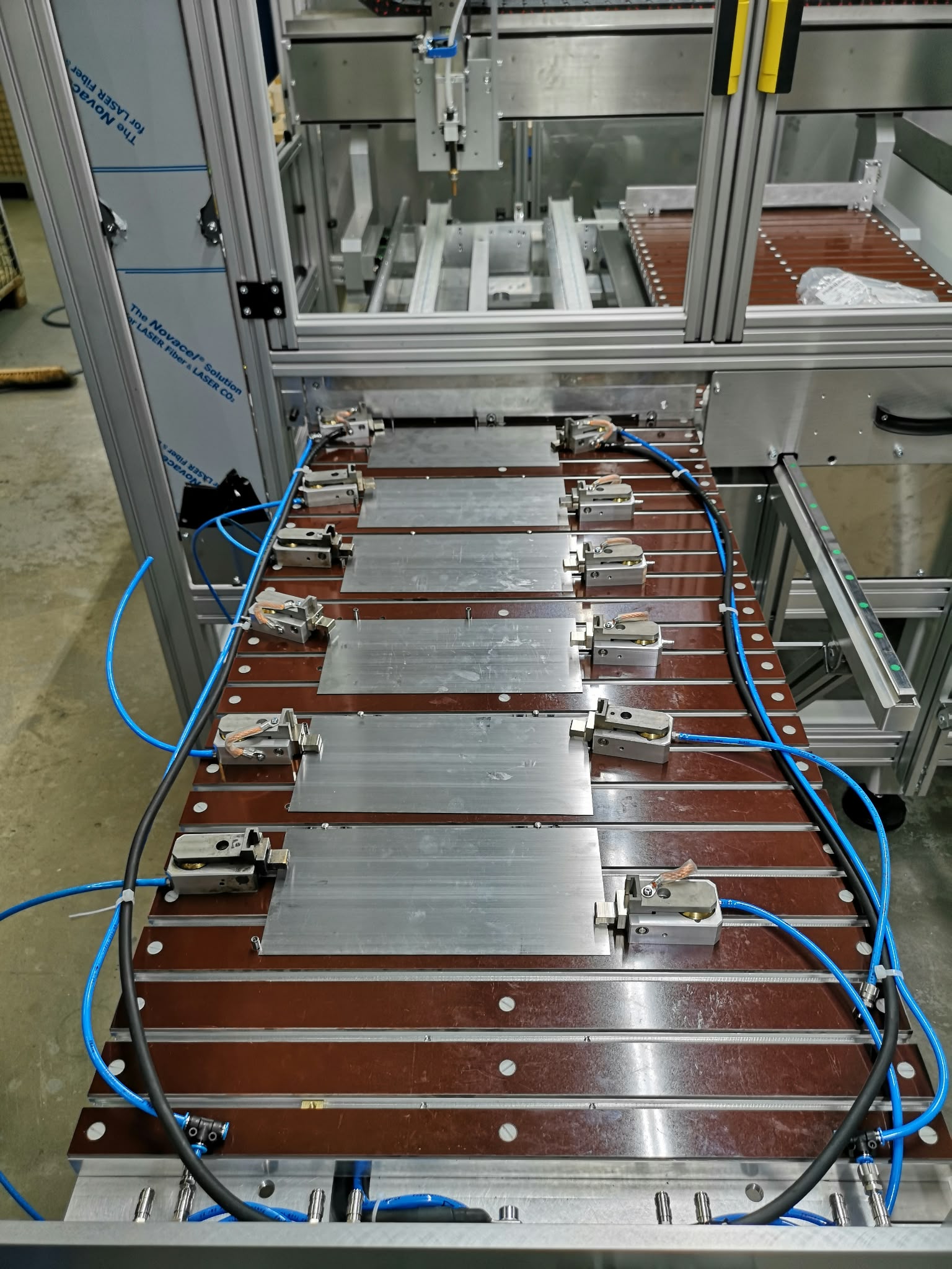 Loaded shuttle table with several workpieces and clamps.