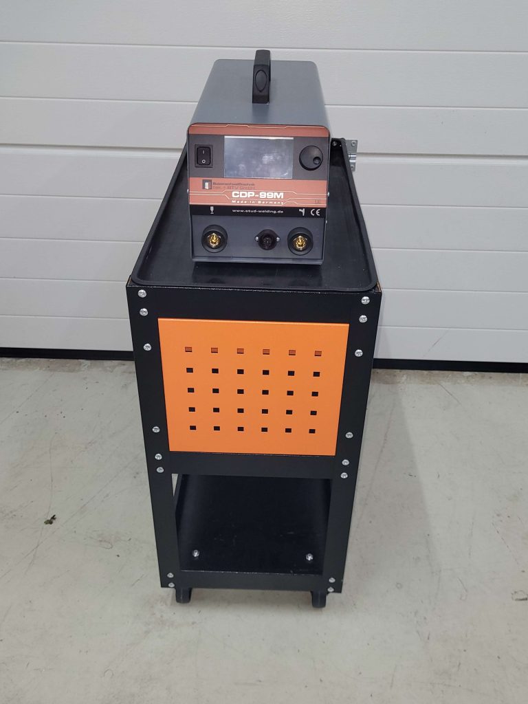 Front view of the equipment trolley with CDP welding unit, drawer and shelves